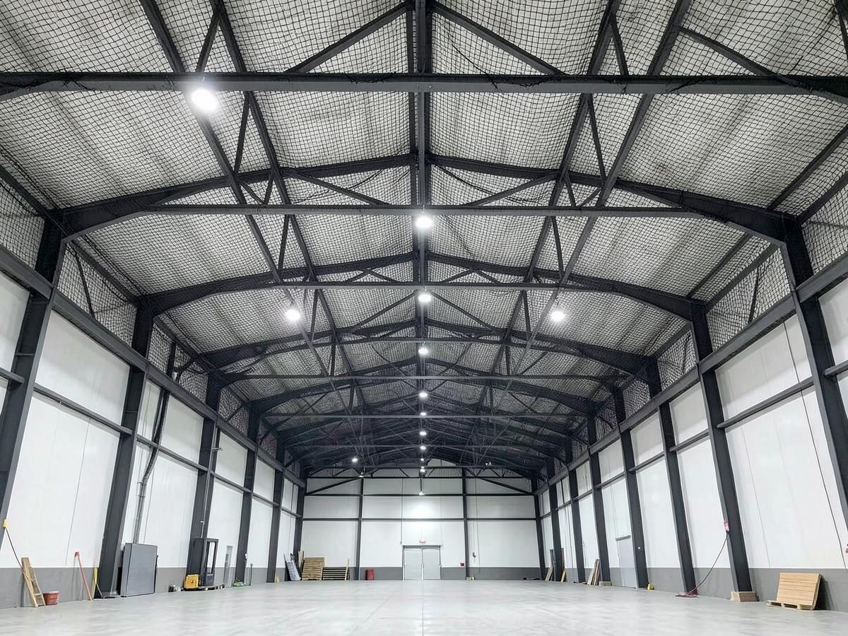 Heavy duty bird netting installed under the roof trusses of a warehouse in Maharashtra