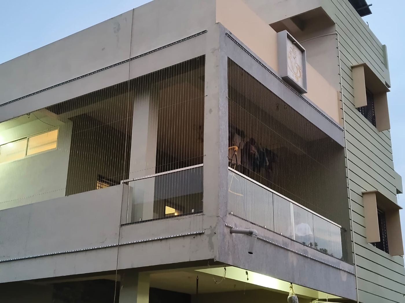 Side view of a covered balcony with invisible grill cables and glass railing