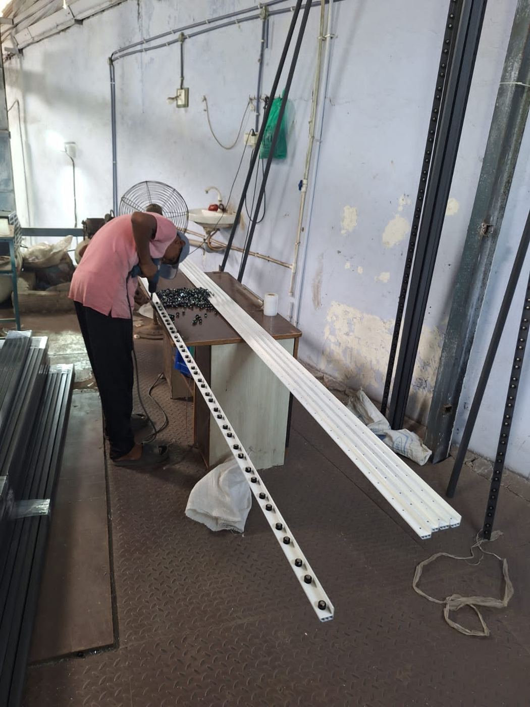 Aluminium invisible grill track being cut to length in the workshop