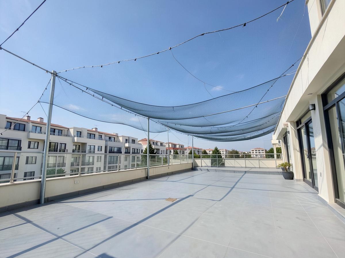 Bird protection net installed over an open building span in Maharashtra